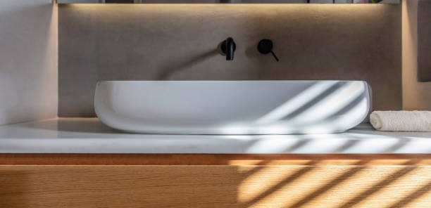 istock Bathroom sink basin and faucet modern interior design. Black taps and white washbasin, 1349210678
