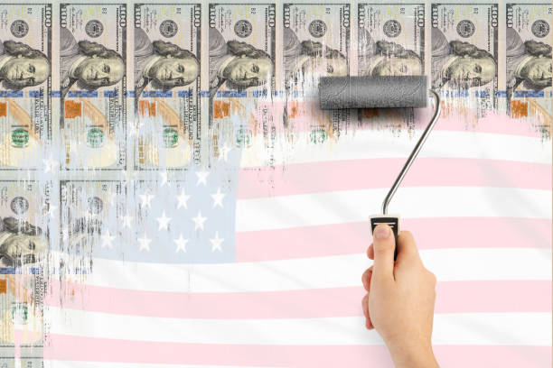 Money printing. Printing press of US dollars. Economic incentives. Inflation and the economic crisis. Male hand draws us dollars with a roller to paint the walls. Stock market bubble concept Money printing. Printing press of US dollars. Economic incentives. Inflation and the economic crisis. Male hand draws us dollars with a roller to paint the walls. Stock market bubble concept. one hundred dollar stamp stock pictures, royalty-free photos & images
