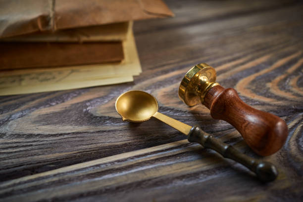 istock Sealing wax on ancient papers, antique stamp, and old documents, brass spoon 1349220797