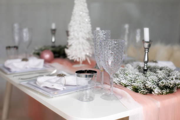 istock Beautiful Christmas dinner setting. Festive table setting with a tablecloth among winter decorations and white candles. Top view, flat lay. The concept of Christmas or New year family dinner. 1349220849