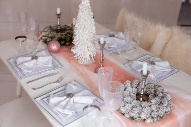 istock Beautiful Christmas dinner setting. Festive table setting with a tablecloth among winter decorations and white candles. Top view, flat lay. The concept of Christmas or New year family dinner. 1349220902