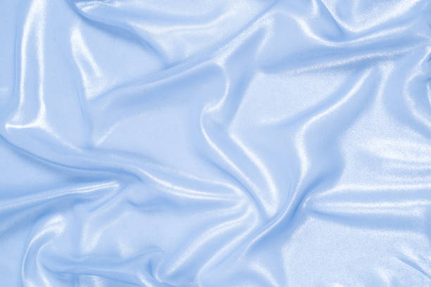 Blue shiny pearl fabric as a background. Top view.