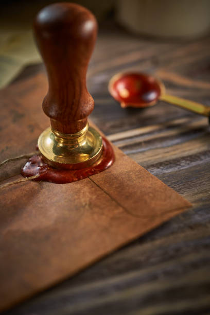 istock Sealing wax on ancient papers, antique stamp, and old documents, brass spoon 1349221060