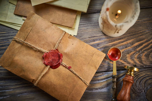 istock Sealing wax on ancient papers, antique stamp, and old documents, brass spoon 1349221063