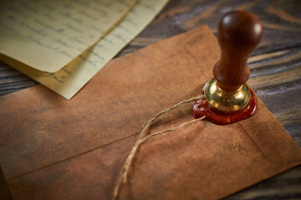 istock Sealing wax on ancient papers, antique stamp, and old documents, brass spoon 1349221184