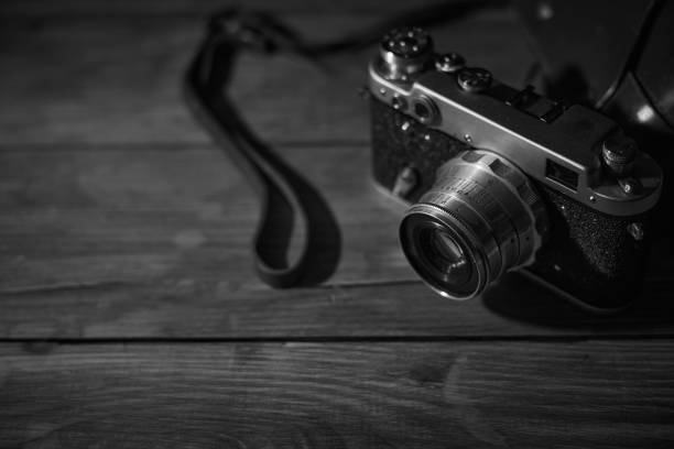 istock Old vintage camera on a desk, cinematic noir scene 1349221259