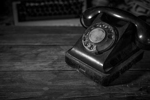 Old vintage phone on a desk, cinematic noir scene