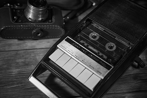 Old vintage tape recorder on a desk, cinematic noir scene