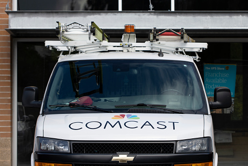 Tigard, OR, USA - Oct 6, 2021: Closeup of a Comcast Xfinity service van parked outside a building in Tigard, Oregon.