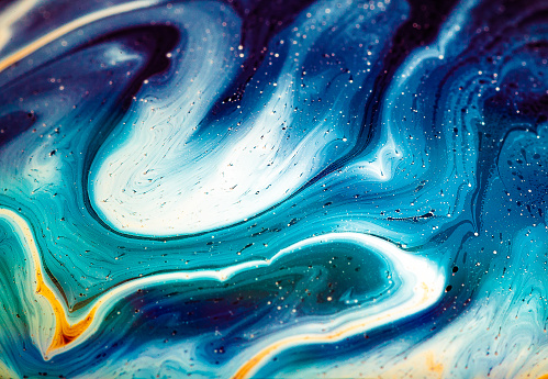 Macro color image depicting the colorful multi colored swirl patterns that appear when mixing oil and water.