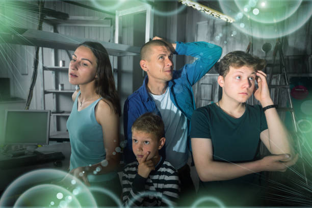Family solving conundrums in quest room stylized as bunker