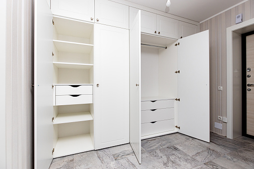 wardrobes with hinged doors on white door hinges, in the apartment. High quality photo