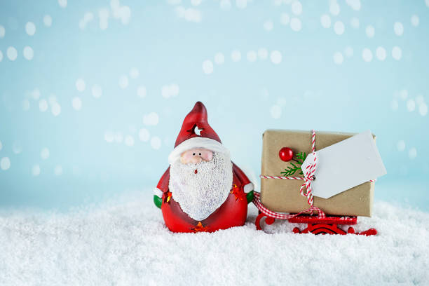 istock Santa Claus with present on red sleigh. 1349229528
