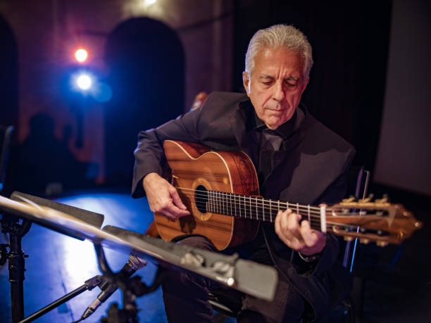 istock Mature male Guitarist on the stage 1349231099