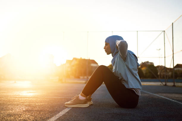 istock Dedicated Muslim sportswoman doing sit-us during outdoor workout 1349231666