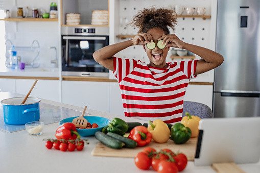 Portrait of a girl having fun while preparing a healthy meal