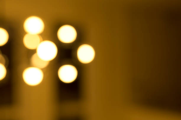 istock Blur background of light bulbs in a dark room 1349232814