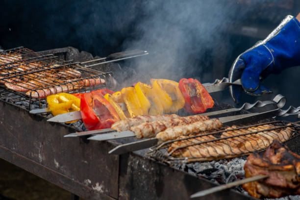 istock Spit meat and vegetables are fried over an open fire. BBQ meat and vegetables 1349232898