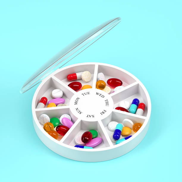 istock Round pill box with different tablets and vitamins for a week. Medication organiser. 3d rendering. 1349234174