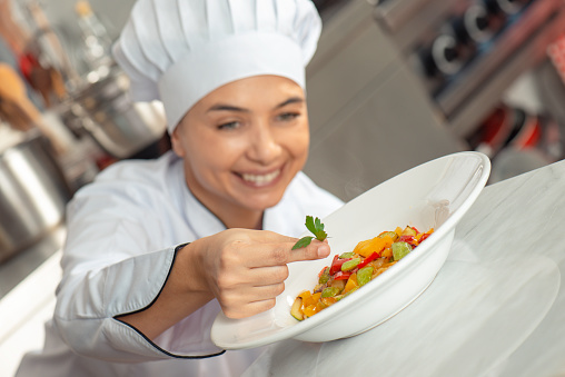 Smiling female chef working.