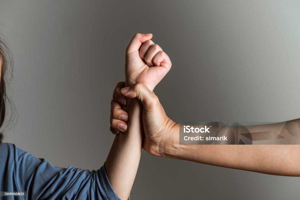 Parental Violence Parent is holding her little girls arm and is about to use violence. Representing child abuse and domestic violence. Domestic Violence Stock Photo