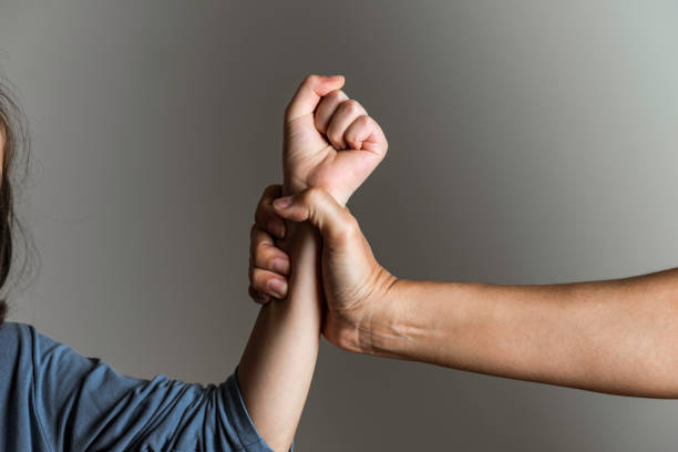 Parental Violence Parent is holding her little girls arm and is about to use violence. Representing child abuse and domestic violence. victim stock pictures, royalty-free photos & images