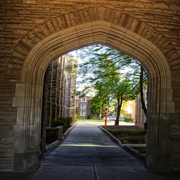 Academic buildings seen through the stone arches - McMaster University, Hamilton, ON, Canada stock photo