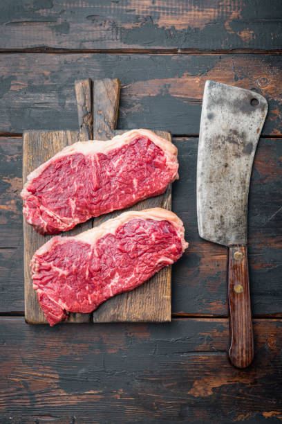 istock Veiny steak, marbled beef meat, on dark wooden background, top view 1349245431