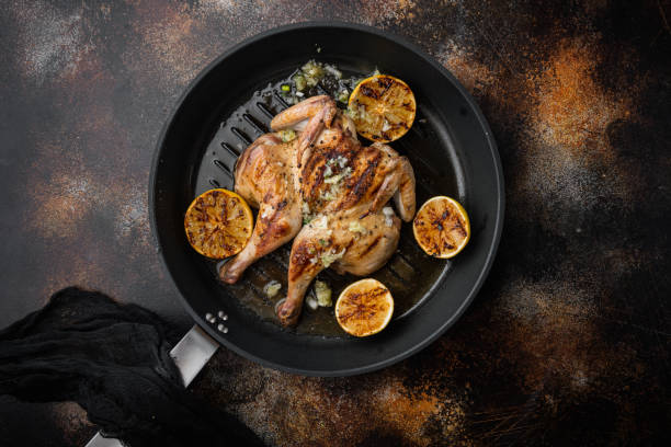 istock Roasted whole poussin, on old rustic background, top view 1349245562