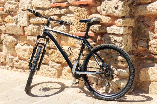 istock Bicycle leaning against the old stone wall 1349246624