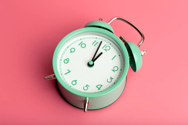 istock Vintage retro alarm clock on a blank colored minimal background. Time, clock, timing concept. 1349246970