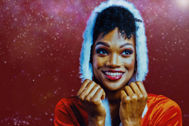 istock Happy Woman Wearing Hood Amidst Snowfall 1349247021