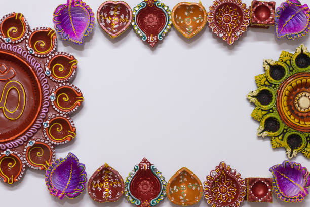 istock Eco Friendly Handmade Handcrafted earthen large biog and small floral Clay Diya Deep Dia arranged as four side border frame background with copy space 1349247759