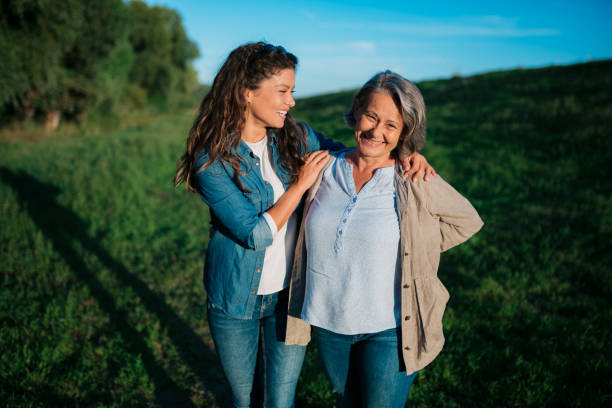 Caucasian mother and daughter celebrating mother's day in nature stock photo