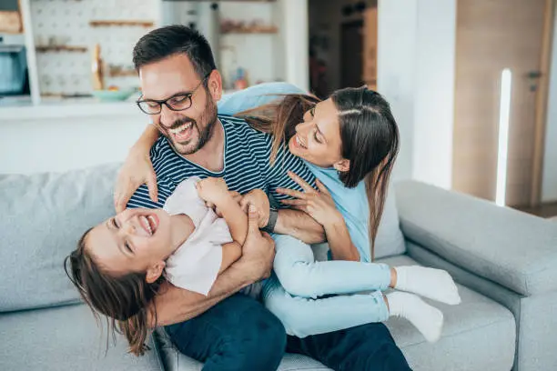 Family with daughter having fun at home