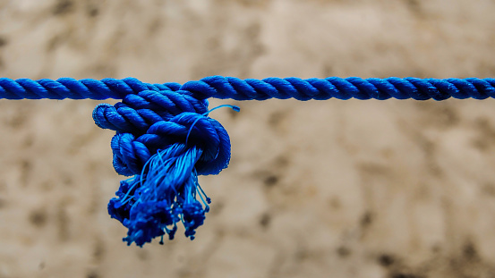 blue rope tied with a knot as a background