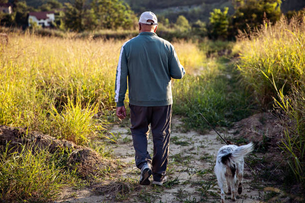 istock Man Enjoying Walking His Dog 1349250798