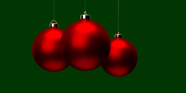 istock Group of red sperical Christmas ornaments on green surface 1349251615