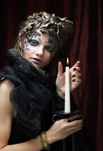 istock Young beautiful woman in a witch costume 1349254280