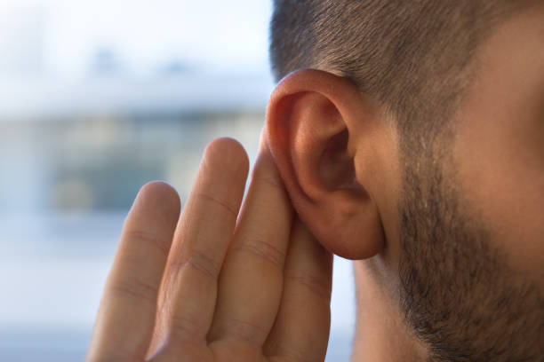 istock Young man with hearing problems, hearing loss or hard of hearing 1349258341