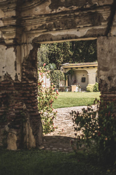 View of a garden through an old wall in Antigua Guatemala, Sacatepéquez Department, Guatemala