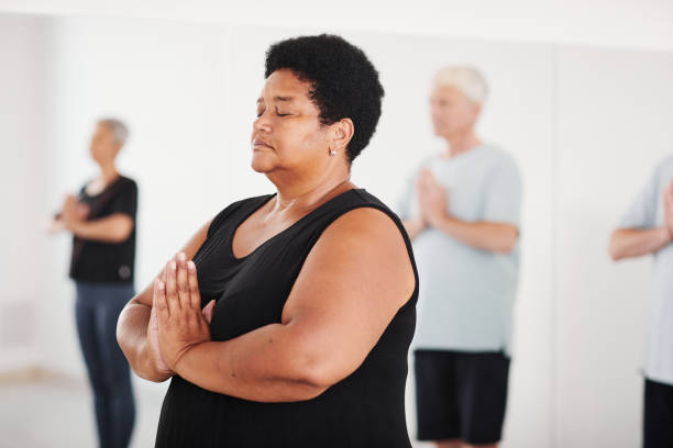 istock Mature woman meditating in yoga class 1349259768
