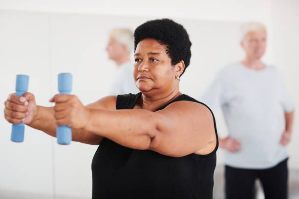istock Woman doing sport exercises with dumbbells 1349259773