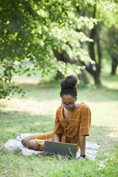 istock African American Woman Using Computer in Park 1349260426