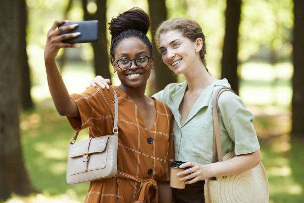 istock Two Friends Taking Photo in Park 1349260477