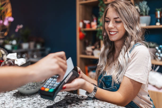 Customer making wireless or contactless payment using credit card.