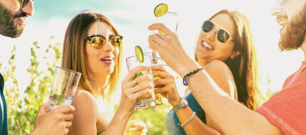 istock Cheerful best friends drinking toasting chilling concept 1349263312