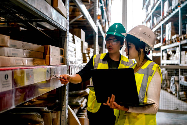 istock Warehouse workers checking stock levels 1349267841