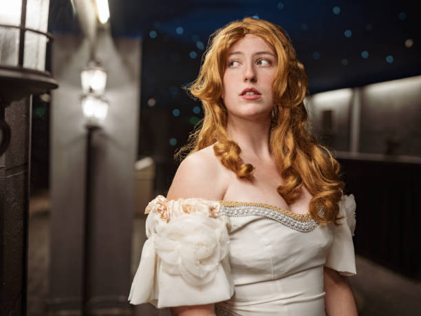 Portrait of young Actress in period costume. Interior of Theatre lobby at night.