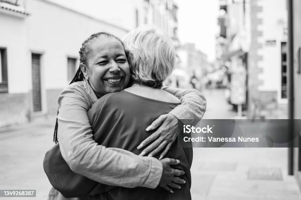 Multiracial Senior Women Hugging Each Other Elderly Friendship And Love Concept Focus On African Woman Face Black And White Edition Stock Photo - Download Image Now
